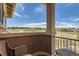 Balcony view of the landscape with seating area to enjoy the outdoors at 3181 Firenze Pl, Highlands Ranch, CO 80126