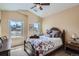 Bright bedroom featuring a ceiling fan, plantation shutters, and a view of the neighborhood at 3181 Firenze Pl, Highlands Ranch, CO 80126