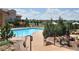 Inviting community pool with lounge chairs, lush landscaping, and views of the surrounding neighborhood at 3181 Firenze Pl, Highlands Ranch, CO 80126