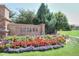 Charming Tresana community sign surrounded by vibrant flowers and lush landscaping at 3181 Firenze Pl, Highlands Ranch, CO 80126
