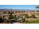 Picturesque community view overlooking lush landscaping and snow-capped mountains in the distance at 3181 Firenze Pl, Highlands Ranch, CO 80126