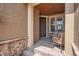 Inviting front porch area with comfortable seating, a welcome mat, and a well-maintained entry at 3181 Firenze Pl, Highlands Ranch, CO 80126