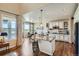 Open kitchen features granite counters, an island with seating, and stainless steel appliances at 3181 Firenze Pl, Highlands Ranch, CO 80126