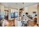 Modern kitchen with island seating, stainless appliances, and an open view of the living room at 3181 Firenze Pl, Highlands Ranch, CO 80126