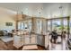 Bright kitchen with granite counters, stainless appliances, and island seating open to the living area at 3181 Firenze Pl, Highlands Ranch, CO 80126