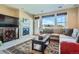 Cozy living room features a stone fireplace, stylish rug, and lots of natural light at 3181 Firenze Pl, Highlands Ranch, CO 80126
