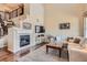 Cozy living room features a stone fireplace, large TV, and comfortable seating, perfect for relaxation at 3181 Firenze Pl, Highlands Ranch, CO 80126