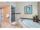 Elegant main bathroom with separate shower, soaking tub, and neutral tile at 3181 Firenze Pl, Highlands Ranch, CO 80126