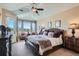Comfortable main bedroom with vaulted ceiling, sitting area, and outdoor views at 3181 Firenze Pl, Highlands Ranch, CO 80126