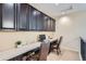 Functional office space with built-in cabinetry and dual desk setup for productivity at 3181 Firenze Pl, Highlands Ranch, CO 80126