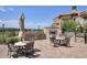 Outdoor kitchen featuring a built-in grill, fireplace, and patio seating at 3181 Firenze Pl, Highlands Ranch, CO 80126