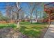 Green backyard featuring a wooden deck with stairs, a shed, and a wood fence at 7065 S Willow St, Centennial, CO 80112