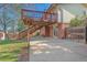 The backyard features a wooden deck with stairs leading to a concrete patio at 7065 S Willow St, Centennial, CO 80112