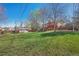 Spacious backyard with a wooden deck, shed, and a lush green lawn at 7065 S Willow St, Centennial, CO 80112