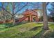 The backyard features a wooden deck with stairs and a large grassy area at 7065 S Willow St, Centennial, CO 80112