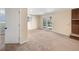 Spacious finished basement with neutral carpet, fireplace, and sliding glass doors to the backyard at 7065 S Willow St, Centennial, CO 80112