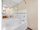 Relax in the large soaking tub with jets, surrounded by tiled walls at 7065 S Willow St, Centennial, CO 80112