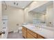 Bathroom featuring a large mirror, single sink vanity, and tiled flooring at 7065 S Willow St, Centennial, CO 80112