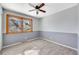 Bedroom with a ceiling fan, two tone paint, and natural light from the window at 7065 S Willow St, Centennial, CO 80112