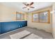 Bright bedroom with large windows and decorative wall paneling. Empty room at 7065 S Willow St, Centennial, CO 80112