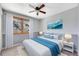 Bright bedroom with large window, neutral walls, and soothing ocean themed decor at 7065 S Willow St, Centennial, CO 80112