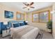 Cozy bedroom with a ceiling fan, hardwood trim windows, and calming blue accents at 7065 S Willow St, Centennial, CO 80112