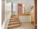 Bright entryway with hardwood stairs, red front door, and coat rack at 7065 S Willow St, Centennial, CO 80112