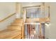 Bright foyer featuring wood floors, staircase, and a view of the upper level at 7065 S Willow St, Centennial, CO 80112