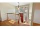 Open foyer with hardwood floors, staircase, and a striking red front door at 7065 S Willow St, Centennial, CO 80112