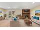 Bright living room with modern furniture, a brick fireplace, and sliding glass doors at 7065 S Willow St, Centennial, CO 80112