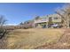 Spacious backyard showcasing a deck, patio area, and a well-maintained lawn, offering a serene outdoor retreat at 314 Woodstock Ln, Castle Pines, CO 80108