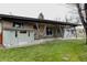 Spacious backyard showcasing a covered patio with architectural beams and access to the lush green lawn at 6530 W 26Th Ave, Edgewater, CO 80214