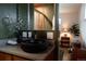 Stylish bathroom features a unique sink, hardwood floors, and olive-green walls at 6530 W 26Th Ave, Edgewater, CO 80214