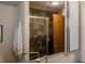 Bathroom featuring a gray tiled shower and a mirrored cabinet at 6530 W 26Th Ave, Edgewater, CO 80214