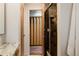 View of the bathroom featuring the gray tiled shower and the red accented room beyond at 6530 W 26Th Ave, Edgewater, CO 80214