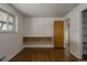 Bright bedroom features hardwood floors, a window, and a built in shelving unit at 6530 W 26Th Ave, Edgewater, CO 80214