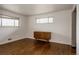 Bright bedroom features hardwood floors, neutral walls, and a wood dresser between the windows at 6530 W 26Th Ave, Edgewater, CO 80214