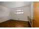 Bedroom with hardwood floors, a large window, and a built-in cabinet at 6530 W 26Th Ave, Edgewater, CO 80214