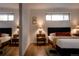Cozy bedroom features hardwood floors, a comfortable bed and a pair of windows at 6530 W 26Th Ave, Edgewater, CO 80214