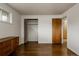 Clean bedroom with hardwood floors, an open closet, and an entry door to other rooms at 6530 W 26Th Ave, Edgewater, CO 80214