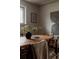 Dining room with wood table, vase of greenery, and neutral decor evokes warmth and sophistication at 6530 W 26Th Ave, Edgewater, CO 80214