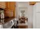 View from kitchen shows dining room with a wood table, chairs, and modern artwork at 6530 W 26Th Ave, Edgewater, CO 80214