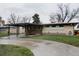 Exterior view of a home with a connected carport, xeriscaping elements and a well-manicured lawn at 6530 W 26Th Ave, Edgewater, CO 80214