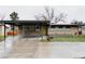Exterior home view showing a carport, brick facade, updated windows, and modern minimalist landscaping at 6530 W 26Th Ave, Edgewater, CO 80214