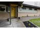 Charming home exterior with a yellow front door, manicured landscaping and mid-century modern design elements at 6530 W 26Th Ave, Edgewater, CO 80214