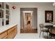 Hallway leading away from an eat-in kitchen with marble table set, cozy and inviting at 6530 W 26Th Ave, Edgewater, CO 80214