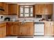 Cozy kitchen featuring wood cabinetry, bay window, and classic white appliances at 6530 W 26Th Ave, Edgewater, CO 80214