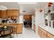 Well-lit kitchen boasts wood cabinetry, modern appliances, and a casual dining area at 6530 W 26Th Ave, Edgewater, CO 80214