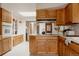 Spacious kitchen features wood cabinets, white countertops, and modern appliances under a skylight at 6530 W 26Th Ave, Edgewater, CO 80214