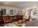 Bright living room with eclectic furnishings, hardwood floors, gallery wall, and decorative shelving unit at 6530 W 26Th Ave, Edgewater, CO 80214